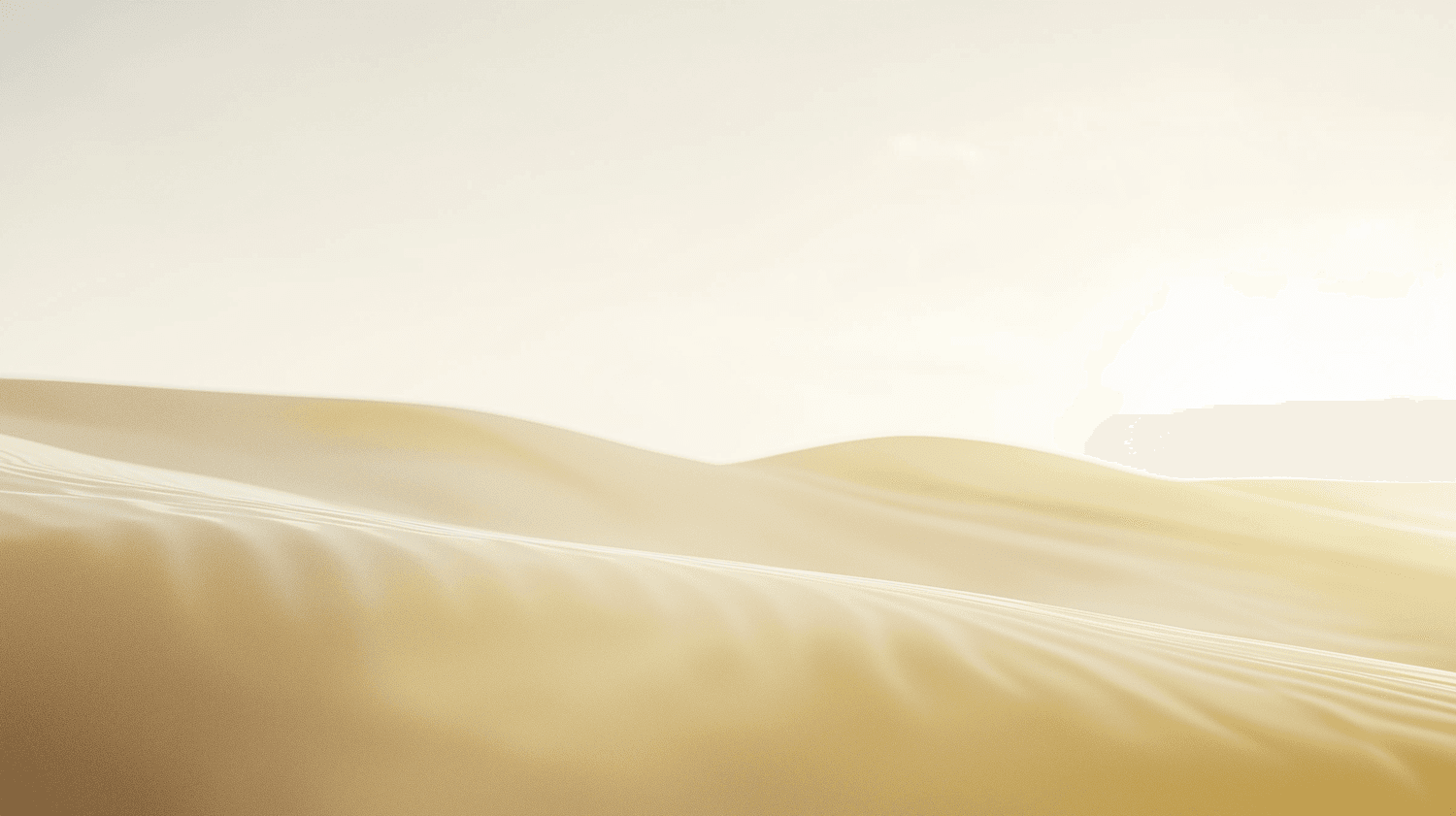 Smooth golden sand dunes under a soft pale sky